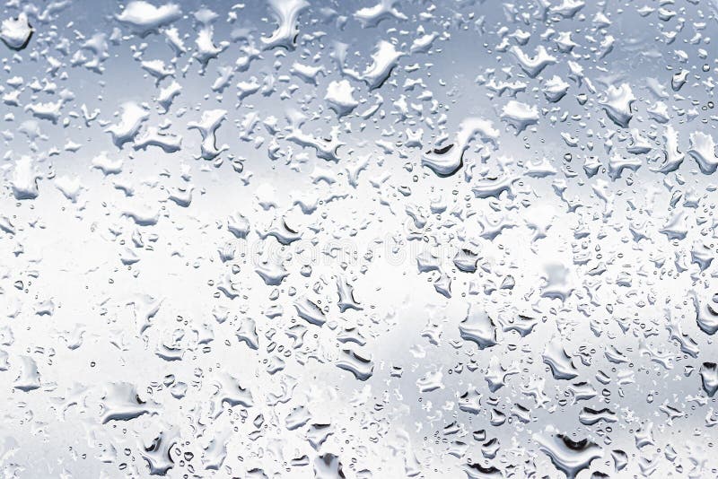 Rain Drops on Window Glasses Surface with Cloudy Background . Natural
