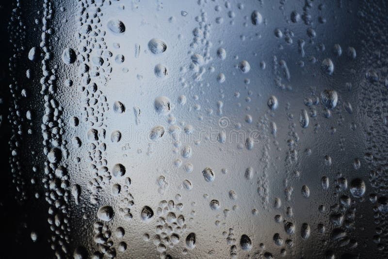Rain Drops on Window Glasses Surface with Cloudy Background . Natural