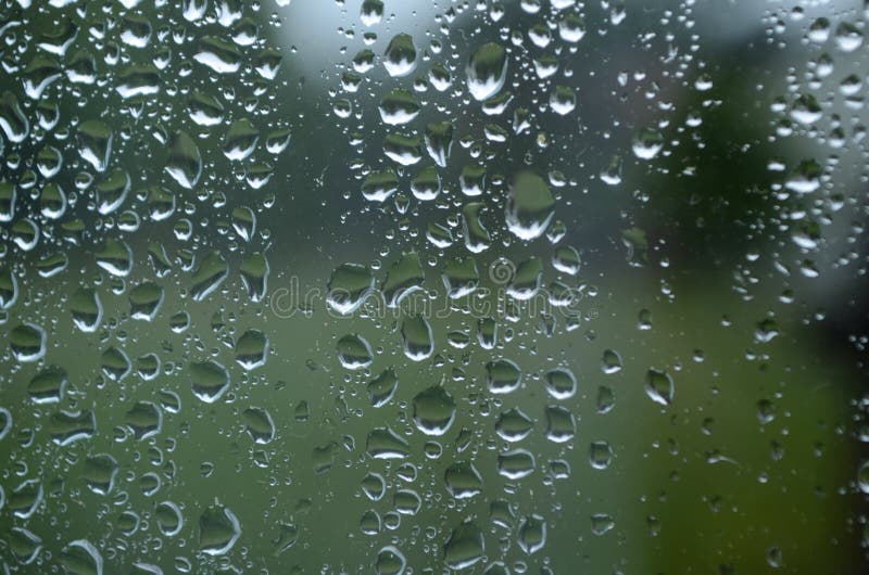 Rain Drops on Window Glasses Surface with Cloudy Background . Natural