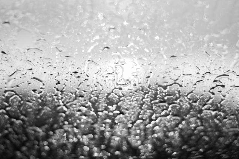 Rain Drops on Window Glasses Surface with Cloudy Background . Stock