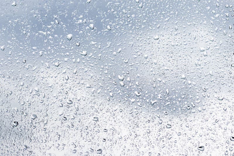 Rain Drops on Window Glasses Surface with Cloudy Sky Background