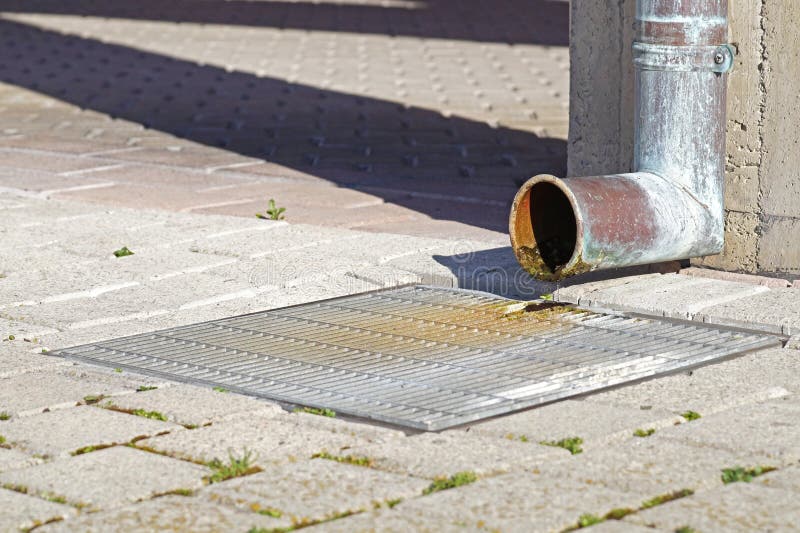Rain gutter draining water away from a roof. royalty free stock images