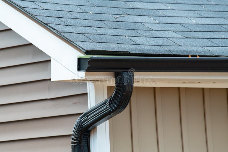 Rain gutter of roof with downpipe stock photo