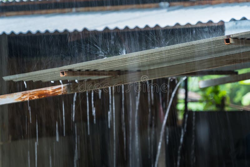 Rain on a Tin Roof. Rain Falling from the Roof. Rainy day nature background. Selective Focus stock photos