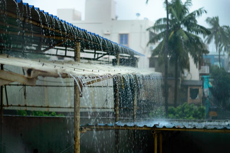 Rain on a Tin Roof. Rain Falling from the Roof. Rainy day nature background. Selective Focus on Foreground stock photos