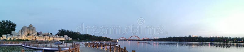 The rainbow bridge in the distance, the woods, the rockery in the distance, the lake royalty free stock images The rainbow bridge in the distance, the woods, the rockery in the distance, the lake royalty free stock images