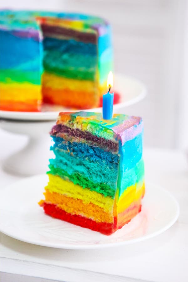 Rainbow Cake and Cupcakes Decorated with Birthday Candles Stock Image