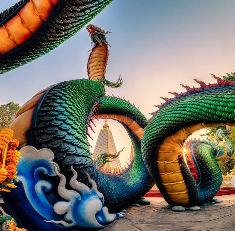 Rainbow carve serpent or colorful Thai Naga surrounding Sri Maha Pho Chedi stupa in the sunset at Wat Phra That Nong Bua stock photos