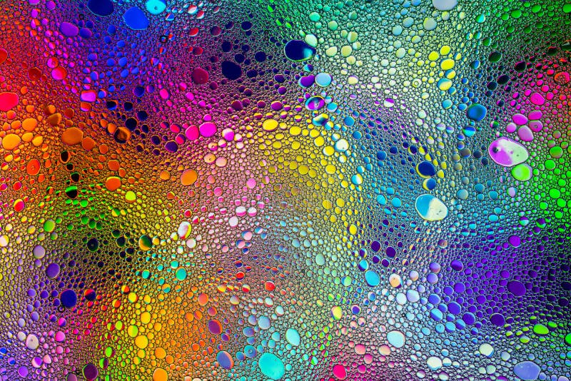 Rainbow color drops of oil on the water