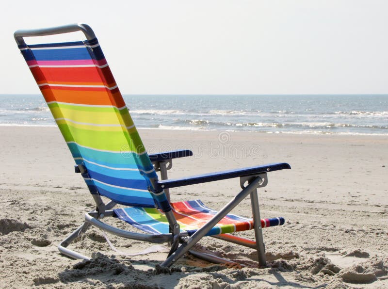 Rainbow colours beach chair on the sand, ocean