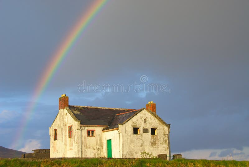 Rainbow over abandoned house