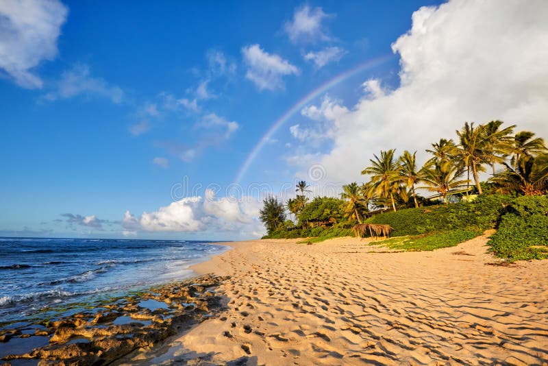 Rainbow scenic view over the popular surfing place Sunset Beach, North Shore, Oahu, Hawaii, USA. Rainbow scenic view over the popular surfing place Sunset Beach, North Shore, Oahu, Hawaii, USA