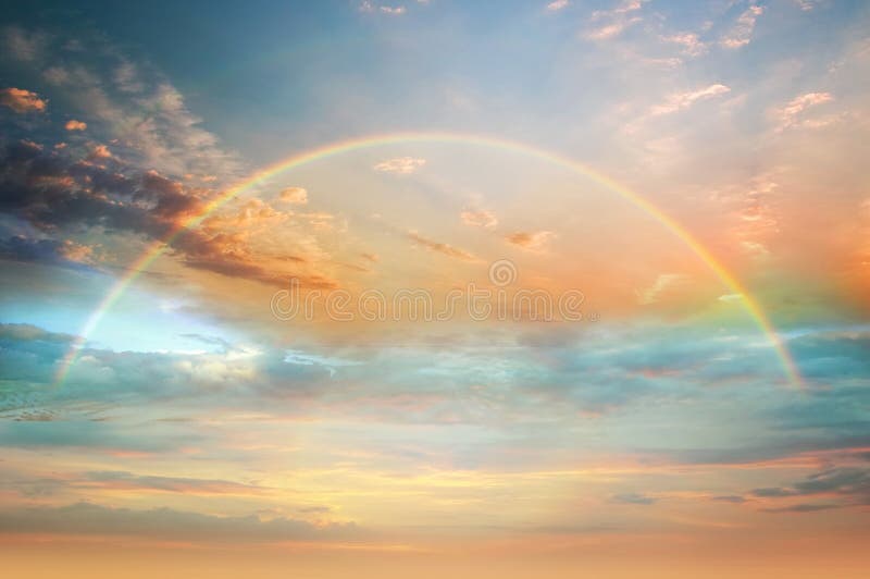 Rainbow colorful  sunset on   blue pink sky yellow  clouds skyline ,water sea reflection beautiful landscape    summer  nature. Rainbow at sunset on   blue pink