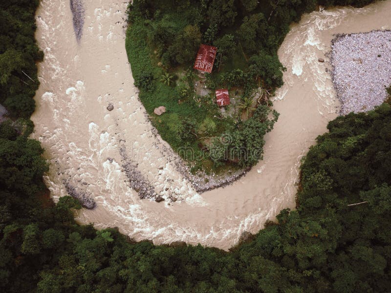 Rainforestflod i Indonesien som hotar för att översvämma kojor Surrskott arkivfoto Rainforestflod i Indonesien som hotar för att översvämma kojor Surrskott arkivfoto