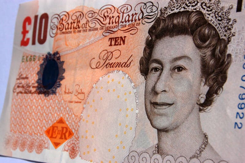 A Bank of England banknote for ten pounds, focus on the figurehead of Queen Elizabeth II. A Bank of England banknote for ten pounds, focus on the figurehead of Queen Elizabeth II.