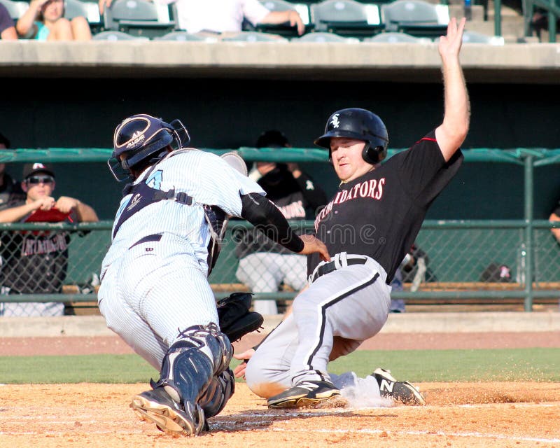 Charleston RiverDogs catcher Rainiero Coa tags a runner at home plate. Charleston RiverDogs catcher Rainiero Coa tags a runner at home plate.