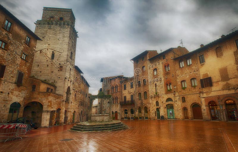 Raining in San Gimignano, Tuscany. Raining in the small but pitoresque medieval town San Gimignano in Tuscany, Italy. Central square Raining in San Gimignano, Tuscany. Raining in the small but pitoresque medieval town San Gimignano in Tuscany, Italy. Central square
