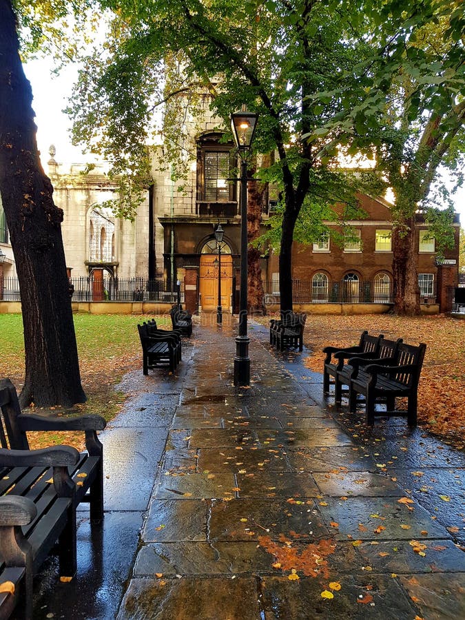 A rainy day evening stroll through Gray Friars grave yard park with empty benches now, with wet old paving stones royalty free stock photo A rainy day evening stroll through Gray Friars grave yard park with empty benches now, with wet old paving stones royalty free stock photo