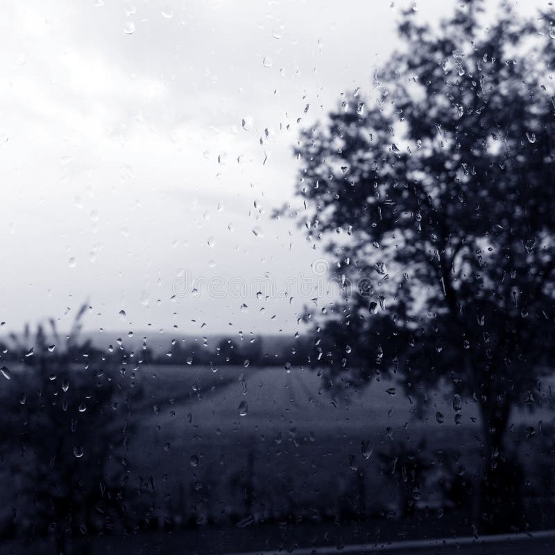 Rainy day window with field countryside view stock photo Rainy day window with field countryside view stock photo