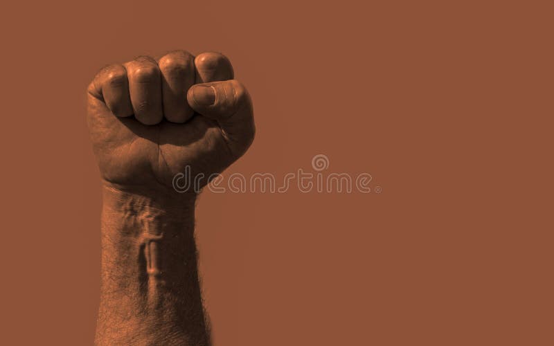 Raised clenched fist with plenty of copy space text or other images. Stock photo with socialism, communism, revolution, workman an