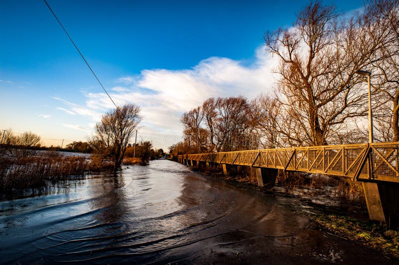 Raised footpath over flooded road. Footpath on stilts runs over a flooded road - closed for vehicles but not pedestrians royalty free stock photography Raised footpath over flooded road. Footpath on stilts runs over a flooded road - closed for vehicles but not pedestrians royalty free stock photography