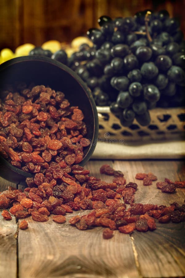 Raisins in bowl and grapes stock photo. Image of kitchen 58850666