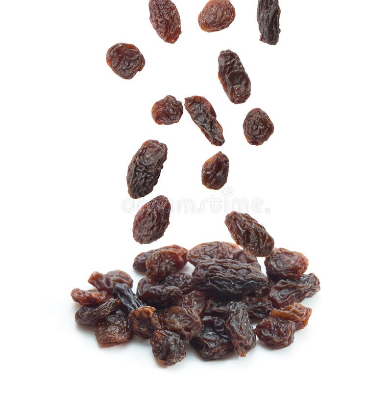 Raisins falling isolated on white background