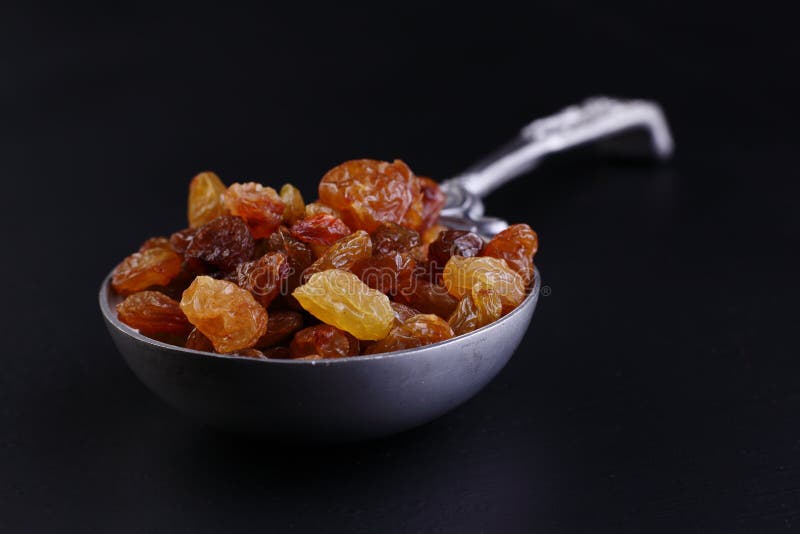 Raisins in steel spoon stock images Raisins in steel spoon stock images