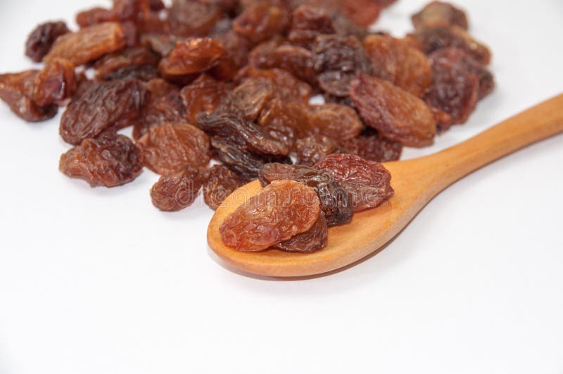 Raisins on a wooden spoon stock photo. Image of raisins - 51724222