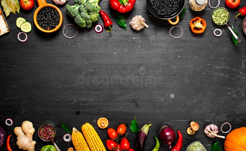 Frame of organic food. Fresh raw vegetables with black beans. On a black chalkboard. Frame of organic food. Fresh raw vegetables with black beans. On a black chalkboard.