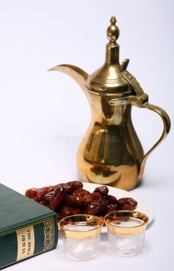 Dates, coffee jug and cups waiting to be filled and a copy of the Holy Qur'an, all are symbolic of the Muslim fasting month of Ramadan and of the breaking of the fast at Iftar. Dates, coffee jug and cups waiting to be filled and a copy of the Holy Qur'an, all are symbolic of the Muslim fasting month of Ramadan and of the breaking of the fast at Iftar.