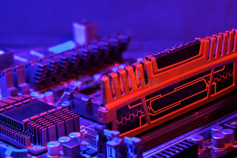 Random access memory the strip is inserted into the motherboard. Motherboard out of the box red-blue backlight. Computer parts. stock photo Random access memory the strip is inserted into the motherboard. Motherboard out of the box red-blue backlight. Computer parts. stock photo
