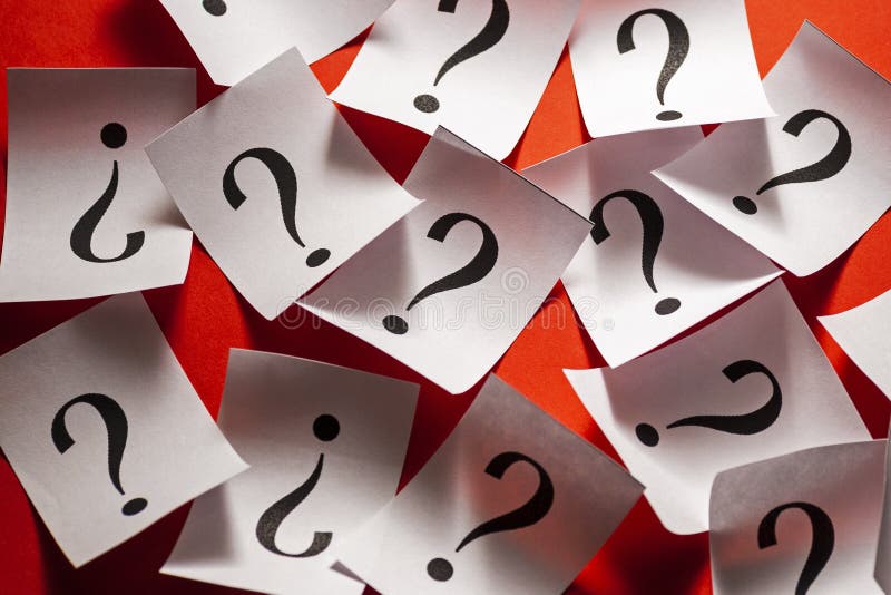 Randomly scattered question marks on white paper royalty free stock photos