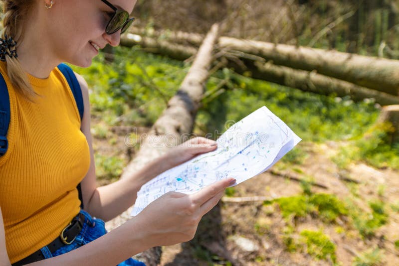 Randonneur de jeune fille dirigeant des mains sur le plan de trekking photo stock Randonneur de jeune fille dirigeant des mains sur le plan de trekking photo stock