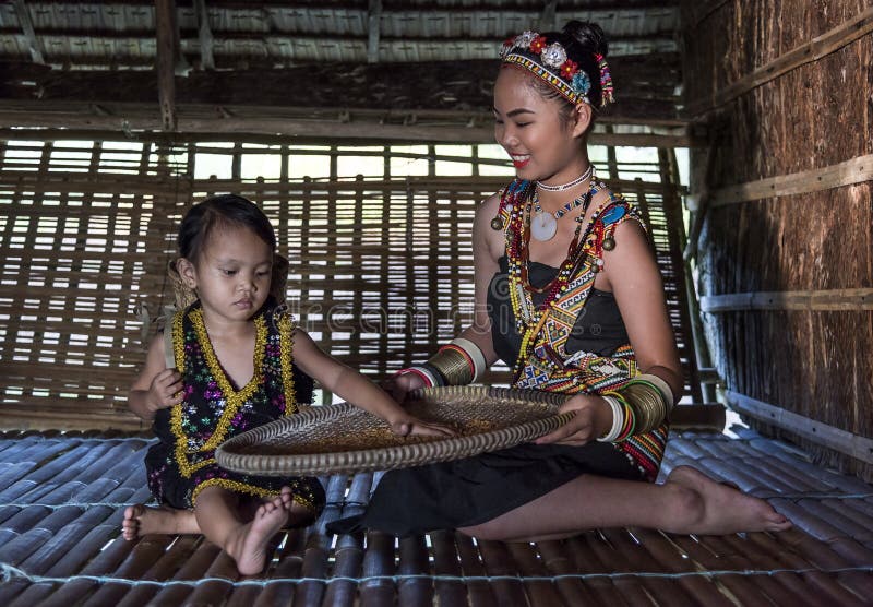Rangus tribal Woman in her traditional tribal costume working in her house in Kudat, Malaysia stock images Rangus tribal Woman in her traditional tribal costume working in her house in Kudat, Malaysia stock images