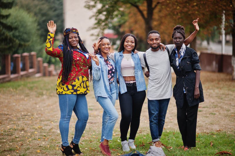Row of group five african college students spending time together on campus at university yard. Black afro friends studying. Education theme. Row of group five african college students spending time together on campus at university yard. Black afro friends studying. Education theme