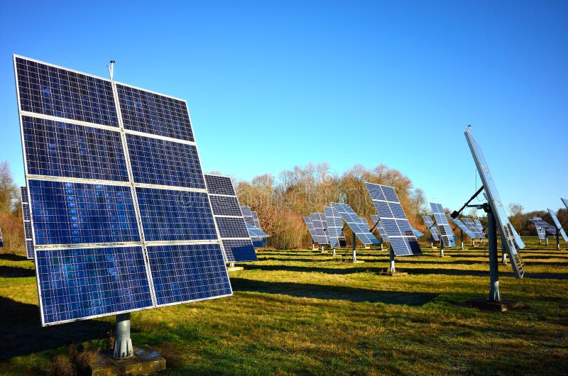 Solar panels erected in a field and converting sunlight into usable energy. A photovoltaic solar power plant in Germany. Solar panels erected in a field and converting sunlight into usable energy. A photovoltaic solar power plant in Germany.