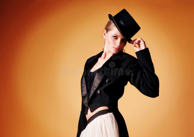 Beautiful young girl in a tuxedo over yellow background. Beautiful young girl in a tuxedo over yellow background