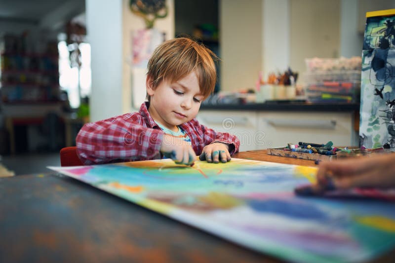 Cute happy little boy, adorable preschooler, painting in a sunny art studio. Young artist at work. Cute happy little boy, adorable preschooler, painting in a sunny art studio. Young artist at work.