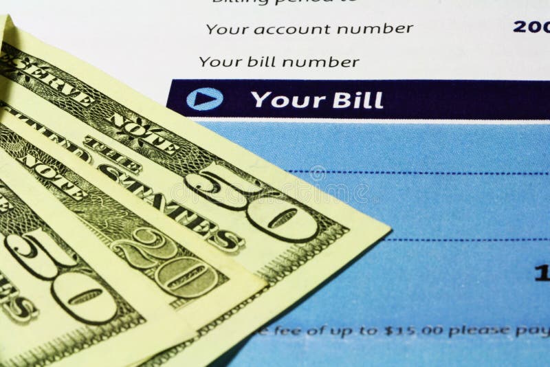 A macro image of U.S. Dollars and an account bill statement. A macro image of U.S. Dollars and an account bill statement