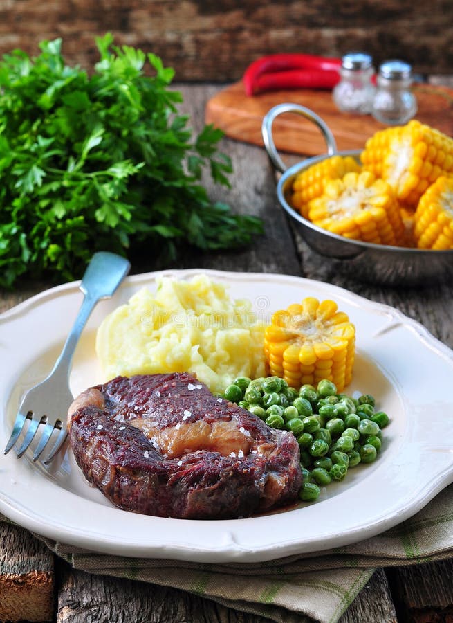 Rare Beef Steak with Mashed Potatoes, Green Peas and Boiled Corn Stock