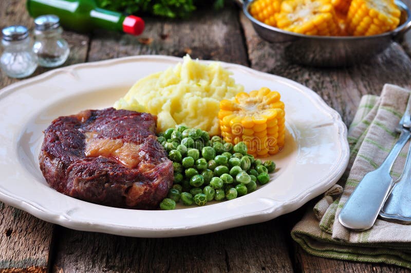 Rare Beef Steak with Mashed Potatoes, Green Peas and Boiled Corn Stock Image Image of green
