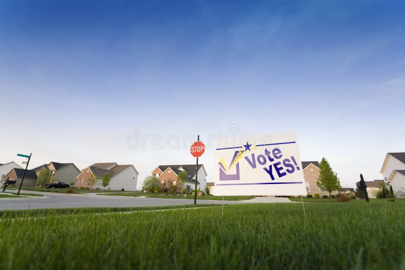 Image of a lawn sign in a neighborhood reading Vote Yes. Image of a lawn sign in a neighborhood reading Vote Yes