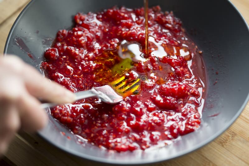 Raspberries smashing with fork