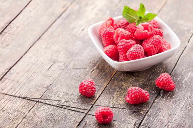 Raspberries on wooden table