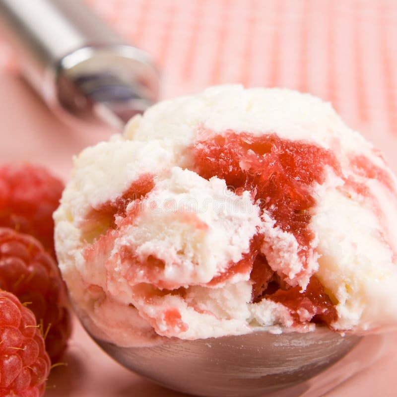 Raspberry ice cream with fresh raspberries on a plate
