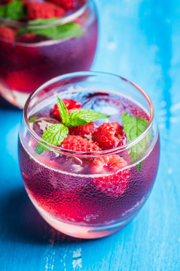 Raspberry and Mint Cocktail in Glass on the Rustic Background Stock