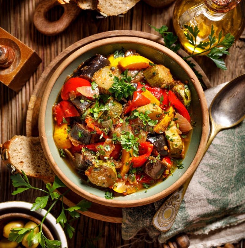 Ratatouille, Vegetarian stew made of zucchini, eggplants, peppers, onions, garlic and tomatoes with addition of aromatic herbs, to