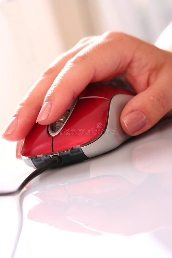 Red computer mouse with women's hand. Red computer mouse with women's hand