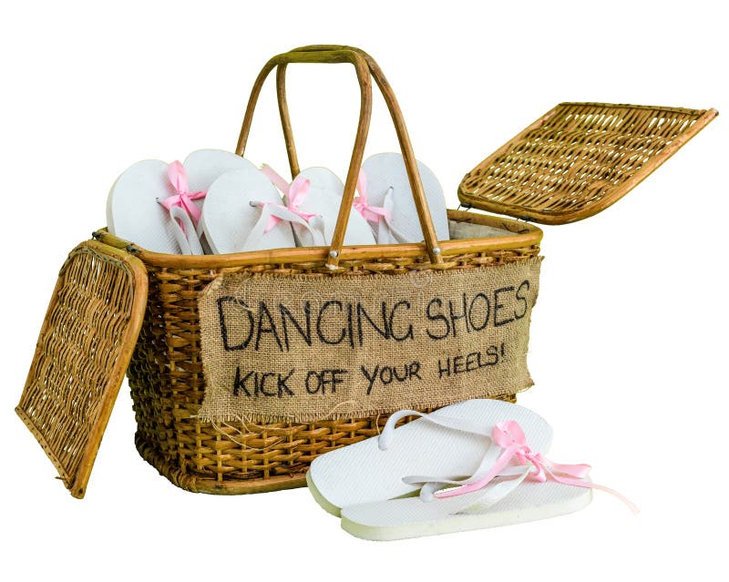 Rattan basket with white flip-flops with pink ribbon bows for guests, with a writing DANCING SHOES. KICK OFF YOUR HEELS! stock photos Rattan basket with white flip-flops with pink ribbon bows for guests, with a writing DANCING SHOES. KICK OFF YOUR HEELS! stock photos